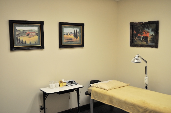 One of the patient rooms with a bed, IR lights, and some medical equipment.